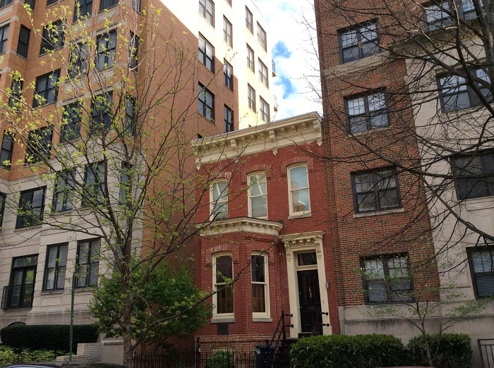 House between two tall buildings